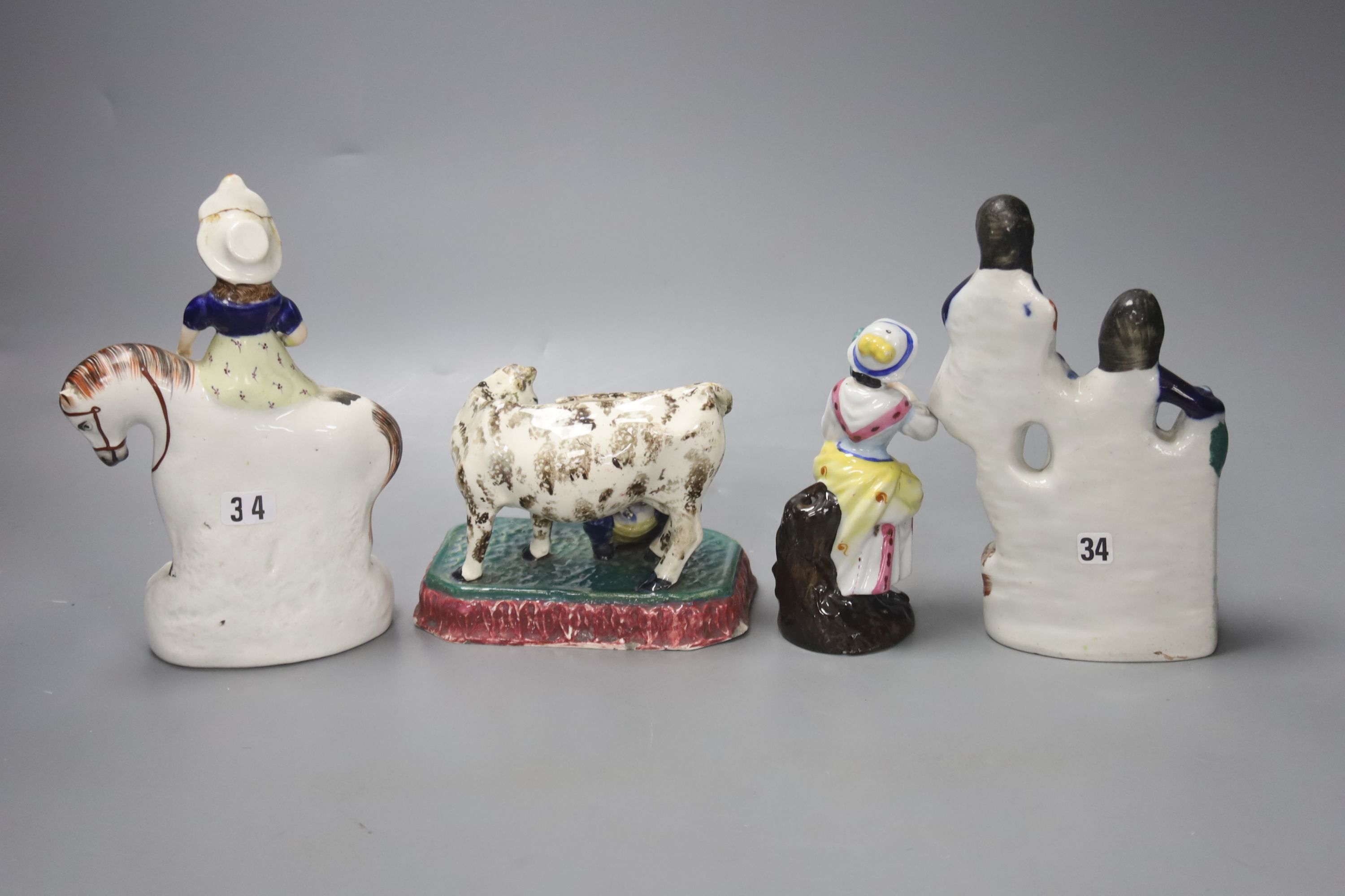 A North Country pearlware milkmaid group, c.1820, two Staffordshire figure groups and a Continental figurine, tallest 18cm